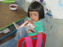 A young girl reads to herself during a Bibliobus visit